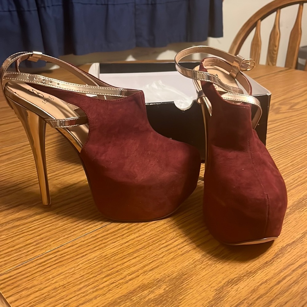 Size 7.5 heels worn once to try on. Wine colored suede with gold.